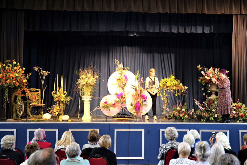 A photo taken at NAFAS Cheshire's 2022 AGM of a demonstration by national demonstrator Alison Penno from Cornwall. The theme was Alison's 'floral idols'