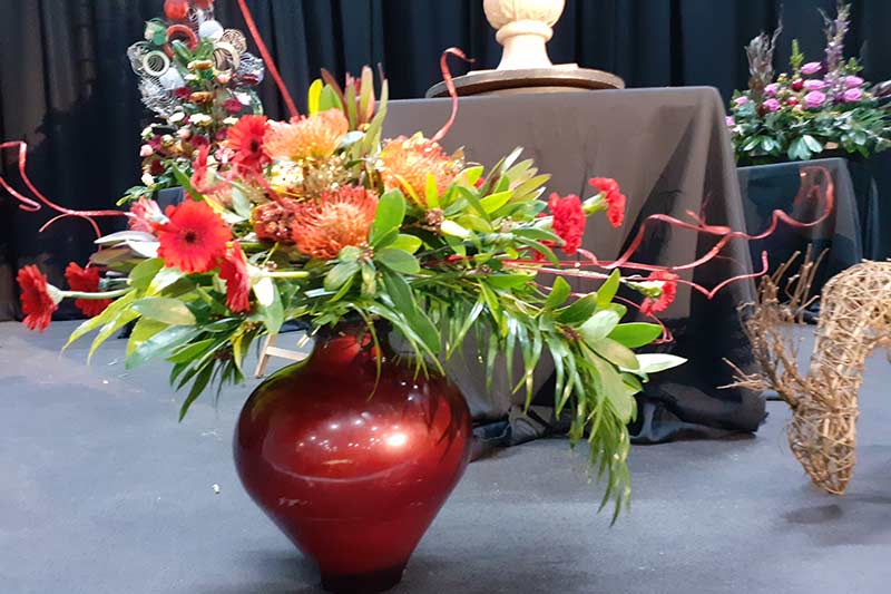 A photo of an arrangement at Ashton Hayes and Tarvin Flower Club's Christmas Meeting