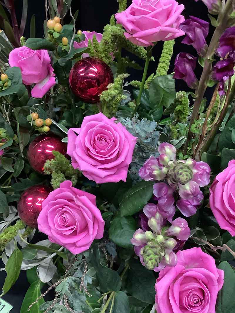 A photo of a gorgeous roses arrangement at Ashton Hayes and Tarvin Flower Club's Christmas Meeting