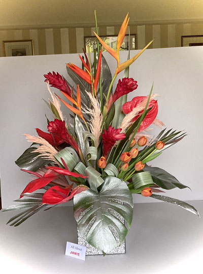 Barbara Fisher's Silver Award Winning flower arrangement in the Don't judge a book ....  class of the Royal Cheshire County 'Virtual' Show 2021