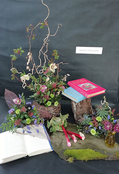 Carole Chia's flower arrangement in the Don't judge a book ....  class of the Royal Cheshire County 'Virtual' Show 2021