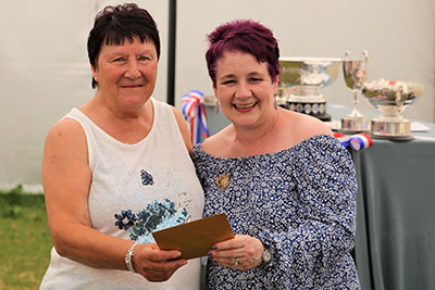 A photo of the 1st place presentation in the Hidden Depths class to Denise Hubbard by Louise Jones. 